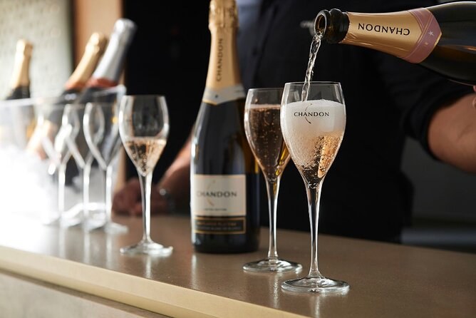 Chandon sparkling wine poured into a branded flute at a tasting bar